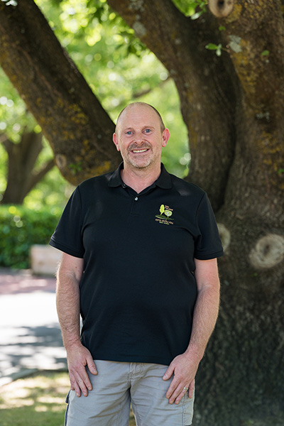 ARO trainer Assessor Chris Barker in aRO polo shirt in front of tree