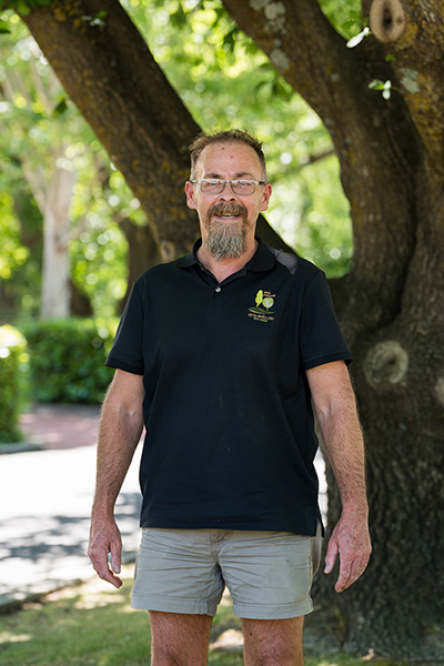 ARO trainer assessor scot Findlay in ARO polo shirt in front of tree
